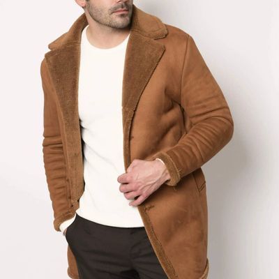 Tan shearling coat styled with simple white shirt