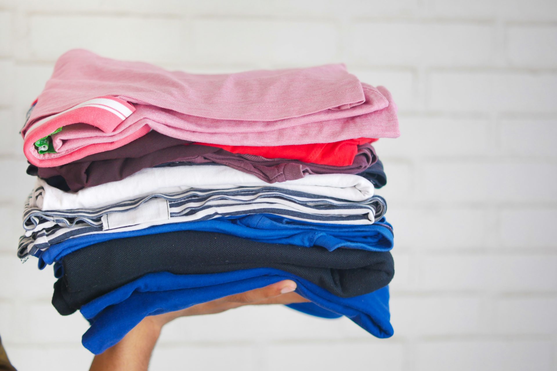 A stack of folded, multi-colored clothes