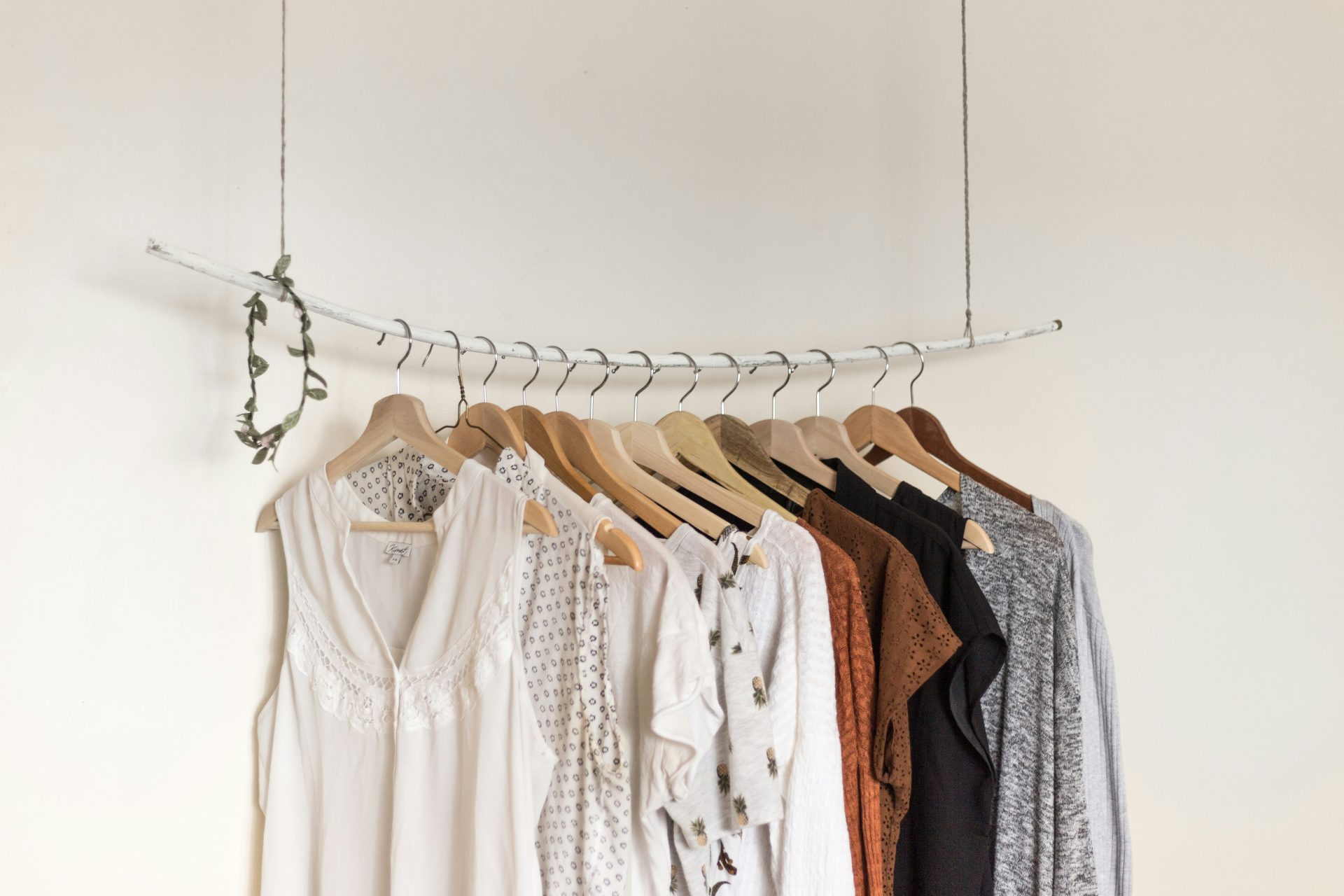 Minimalistic clothing rack with neutral-toned outfits