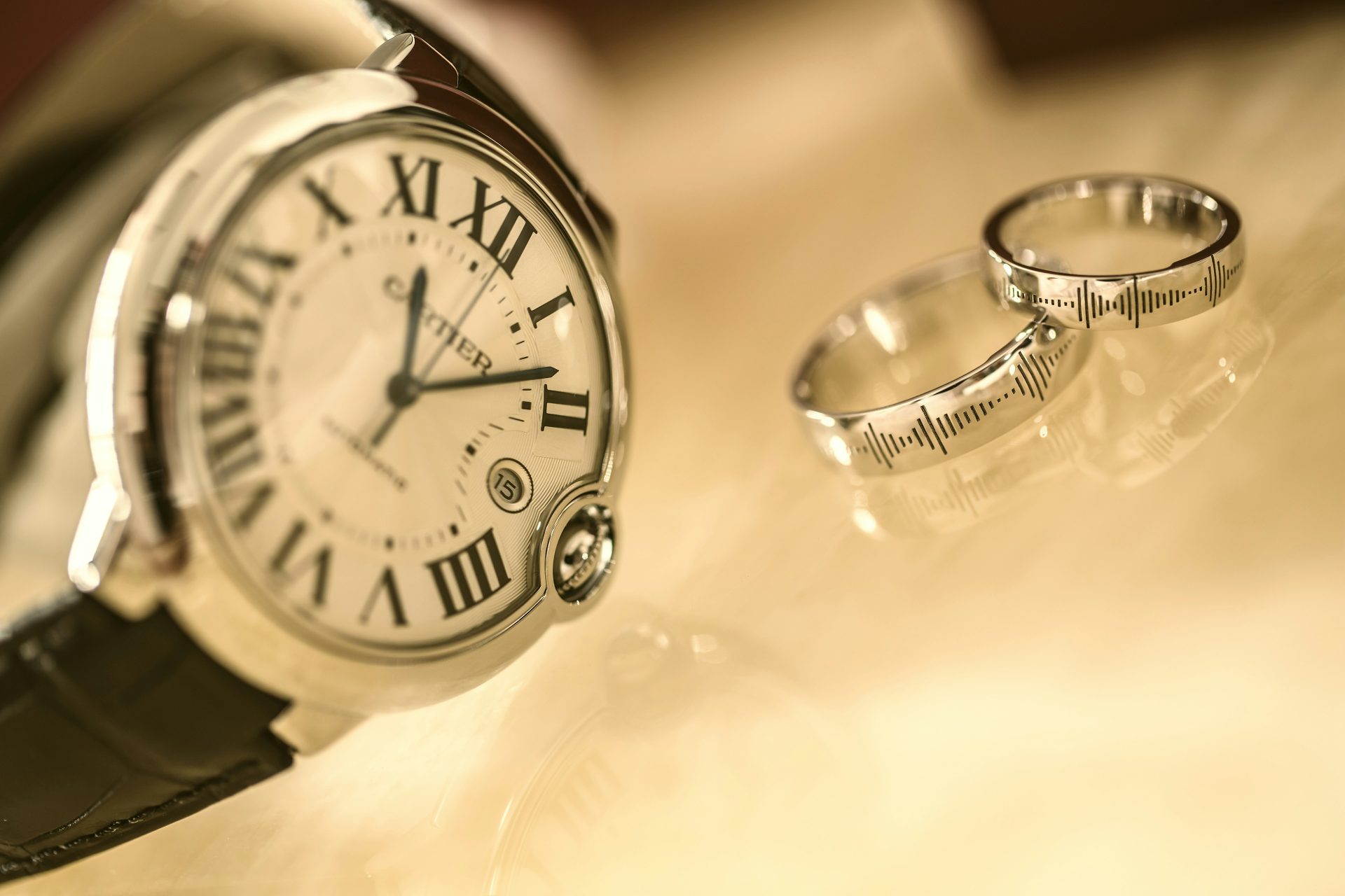 Luxury wristwatch paired with engraved rings