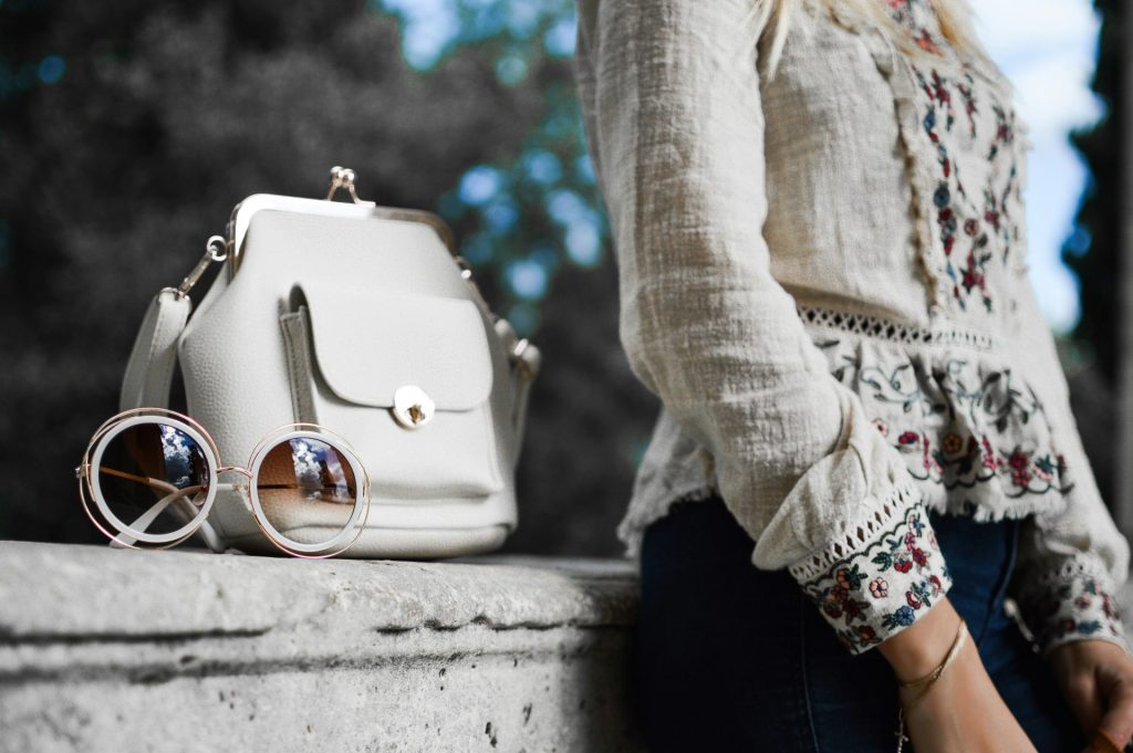 Bohemian blouse paired with sunglasses and bag