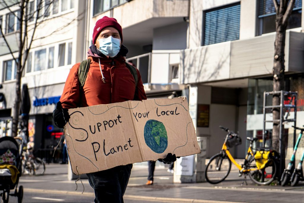 Person holding environmental protest sign