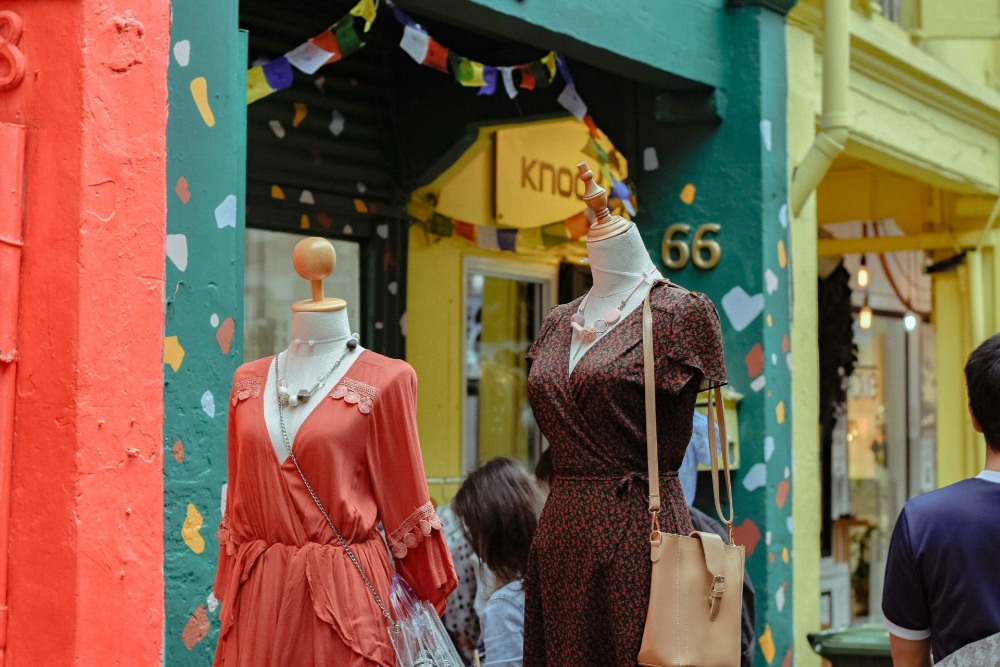 Colorful mannequins outside a boutique storefront